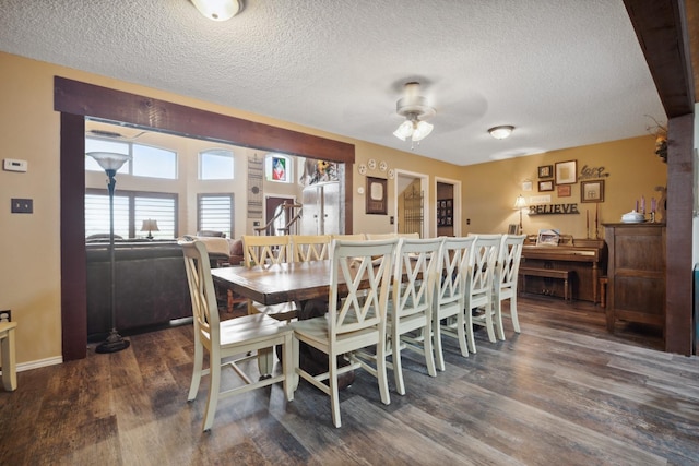 dining area with ceiling fan, dark hardwood / wood-style flooring, and a textured ceiling