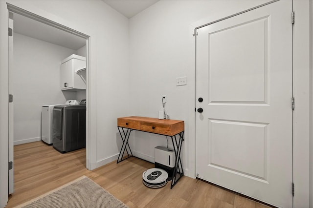 6937 12th St, Lubbock, TX 79416 - clothes washing area with light wood finished floors, independent washer and dryer, cabinet space, and baseboards