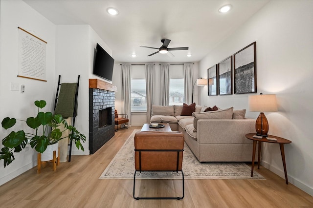 6937 12th St, Lubbock, TX 79416 - living area featuring light wood-style flooring, baseboards, ceiling fan, recessed lighting, and a tiled fireplace
