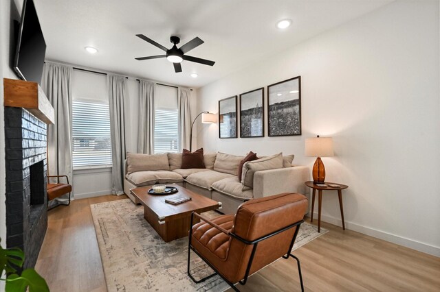 6937 12th St, Lubbock, TX 79416 - living area featuring a fireplace, baseboards, ceiling fan, and wood finished floors