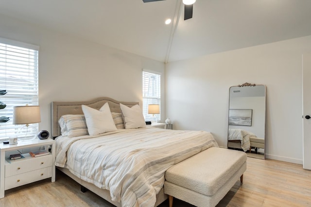 bedroom featuring ceiling fan, lofted ceiling, and light wood-type flooring