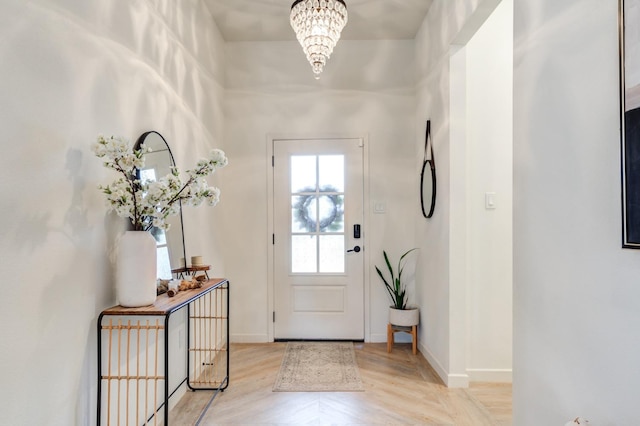 entryway with a notable chandelier and light wood-type flooring