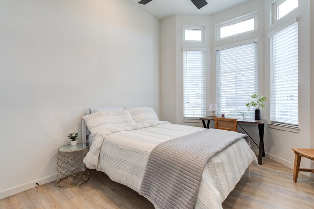 bedroom with light hardwood / wood-style floors and ceiling fan