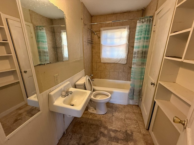 full bathroom with sink, shower / tub combo, and toilet