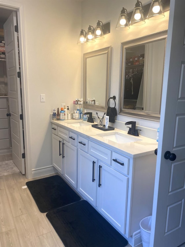 bathroom with vanity and hardwood / wood-style flooring