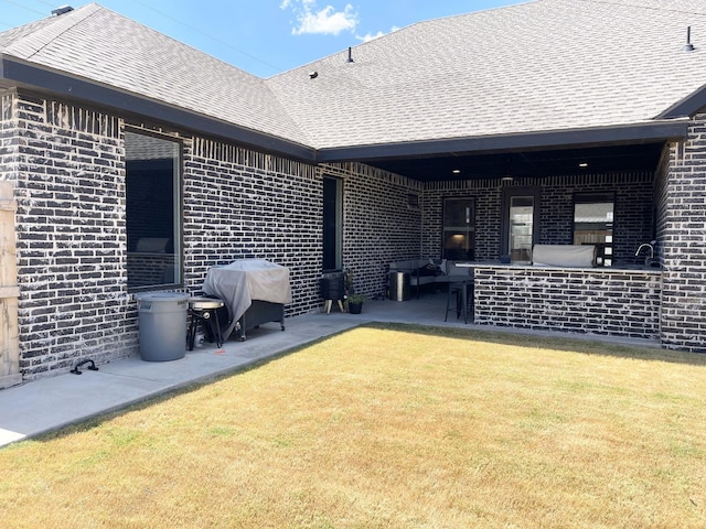 back of house featuring a patio and a yard