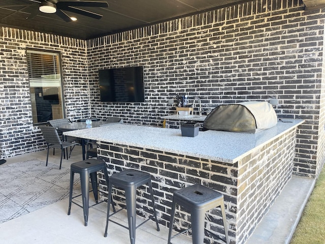 view of patio featuring a bar, ceiling fan, and area for grilling