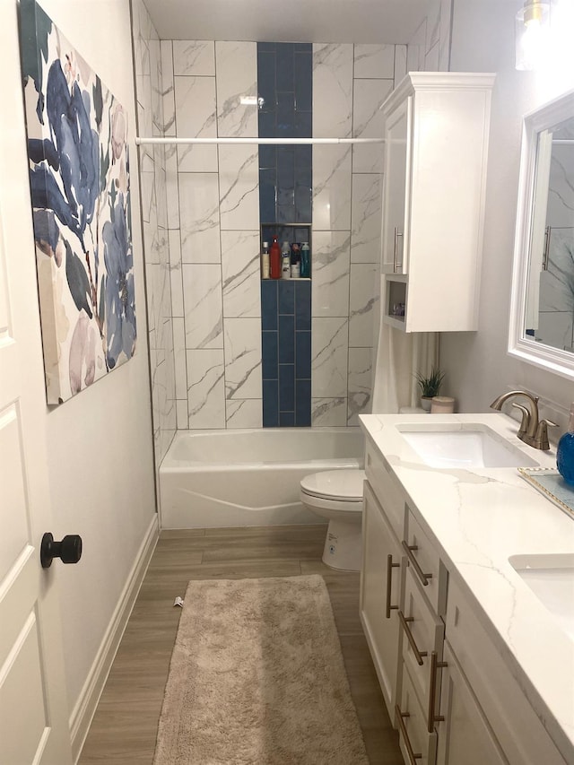 full bathroom featuring vanity, wood-type flooring, toilet, and tiled shower / bath