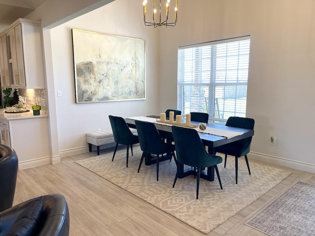 dining room featuring an inviting chandelier and light hardwood / wood-style floors