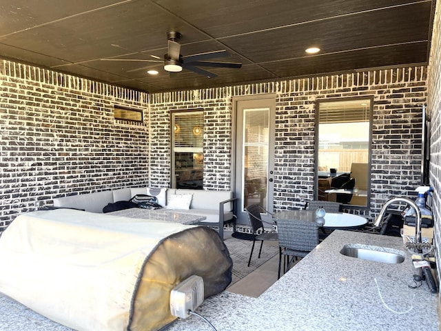 view of patio with sink and ceiling fan