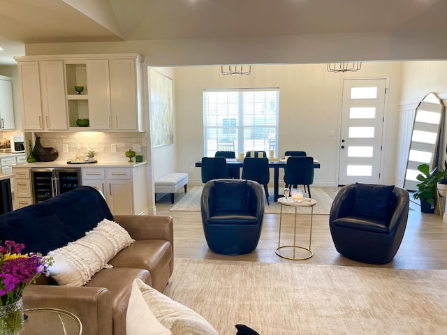 living room featuring wine cooler and light hardwood / wood-style flooring