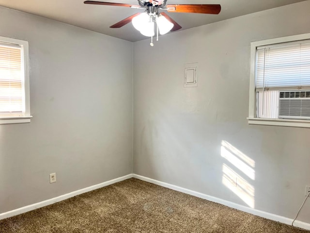 empty room with cooling unit, ceiling fan, and carpet