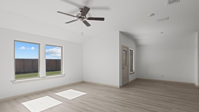 unfurnished room with lofted ceiling, visible vents, light wood finished floors, and ceiling fan