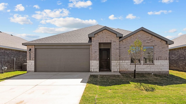 ranch-style home featuring roof with shingles, a front lawn, driveway, stone siding, and a garage