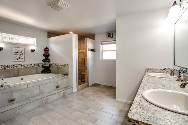 5810 116th St, Lubbock, TX 79424 - full bathroom with double vanity, a garden tub, a tile shower, and a sink