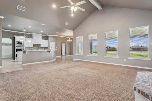 2007 County Rd 7560, Lubbock, TX 79423 - unfurnished living room featuring high vaulted ceiling, a ceiling fan, beam ceiling, arched walkways, and recessed lighting