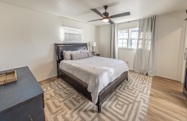 bedroom with light hardwood / wood-style floors and ceiling fan