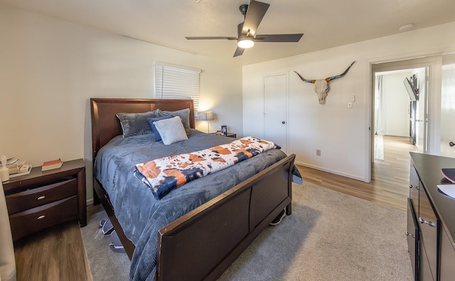 bedroom with light hardwood / wood-style floors and ceiling fan