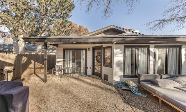 back of property with a patio