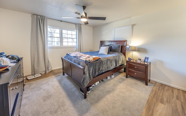 bedroom featuring ceiling fan and light hardwood / wood-style flooring