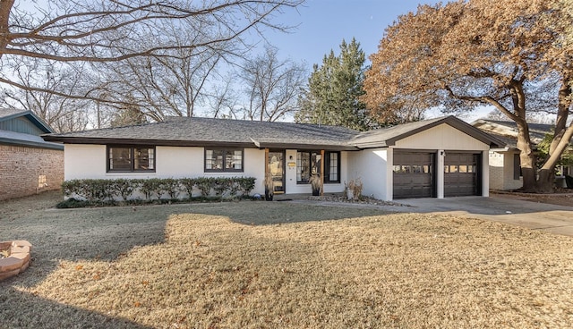 ranch-style home featuring a garage and a front yard