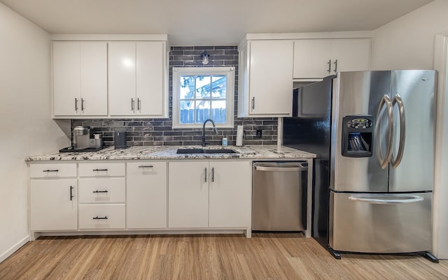 kitchen with sink, white cabinets, and appliances with stainless steel finishes