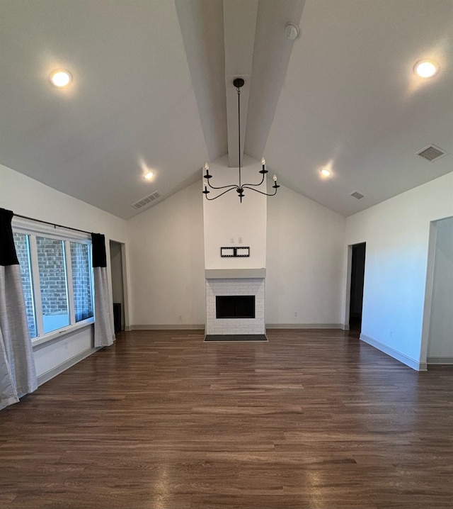 unfurnished living room featuring dark wood-type flooring and lofted ceiling with beams