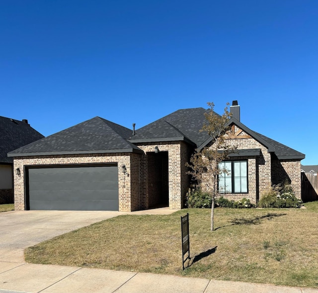 view of front of house featuring a garage and a front lawn