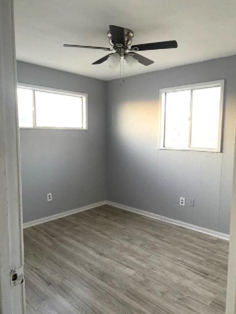 spare room featuring light hardwood / wood-style floors and ceiling fan