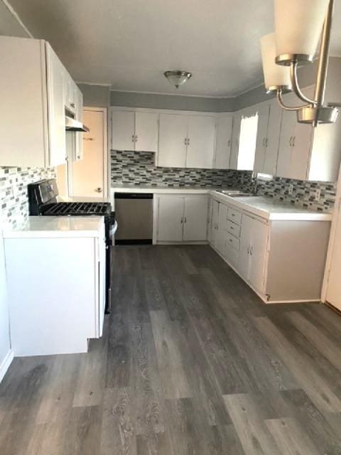 kitchen featuring stainless steel appliances, sink, decorative backsplash, and white cabinets