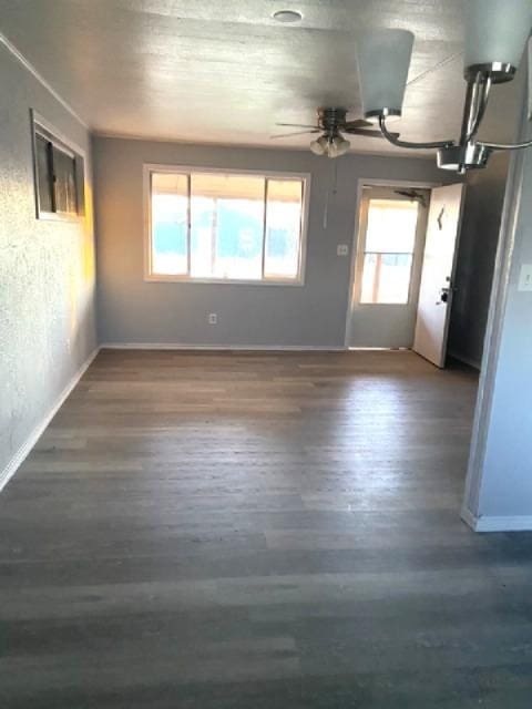 spare room featuring ceiling fan and dark hardwood / wood-style flooring