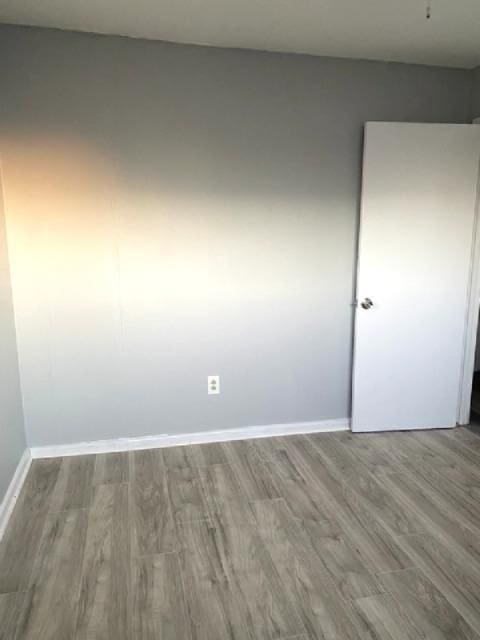 spare room with hardwood / wood-style floors