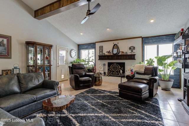 5417 89th St, Lubbock, TX 79424 - living room with light tile patterned floors, plenty of natural light, a fireplace, and ceiling fan