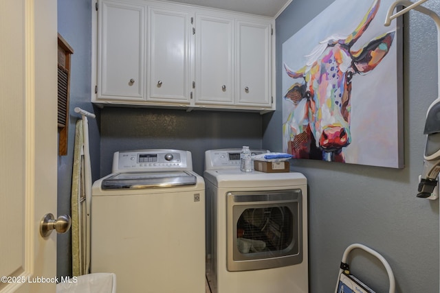5417 89th St, Lubbock, TX 79424 - clothes washing area with cabinet space and washing machine and clothes dryer