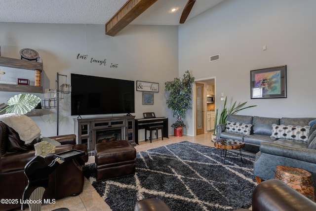 5417 89th St, Lubbock, TX 79424 - living room with a towering ceiling, visible vents, a fireplace, beam ceiling, and light tile patterned floors