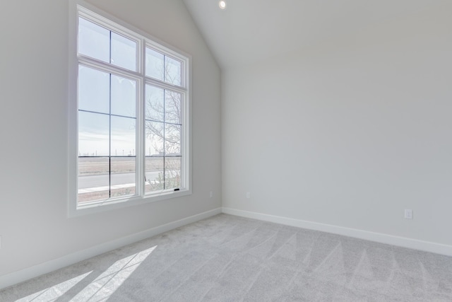 spare room with baseboards, light carpet, and a healthy amount of sunlight