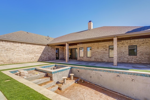 view of pool featuring a patio area, a hot tub, and an empty pool
