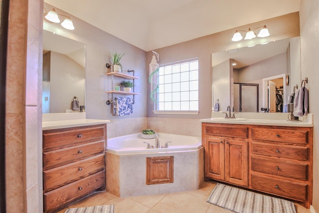 bathroom with a garden tub, a shower stall, vanity, and tile patterned floors