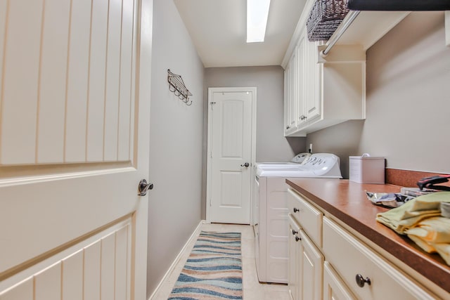 clothes washing area featuring cabinet space, baseboards, separate washer and dryer, and light tile patterned flooring