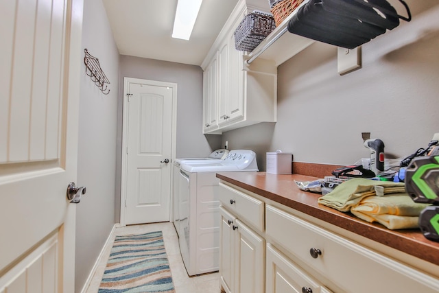 laundry area with washer and dryer, cabinet space, baseboards, and light tile patterned floors