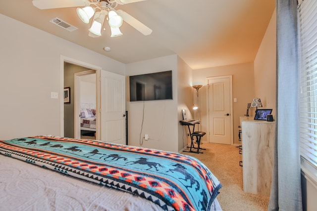 carpeted bedroom featuring visible vents and a ceiling fan