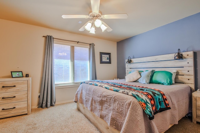 carpeted bedroom featuring a ceiling fan and baseboards