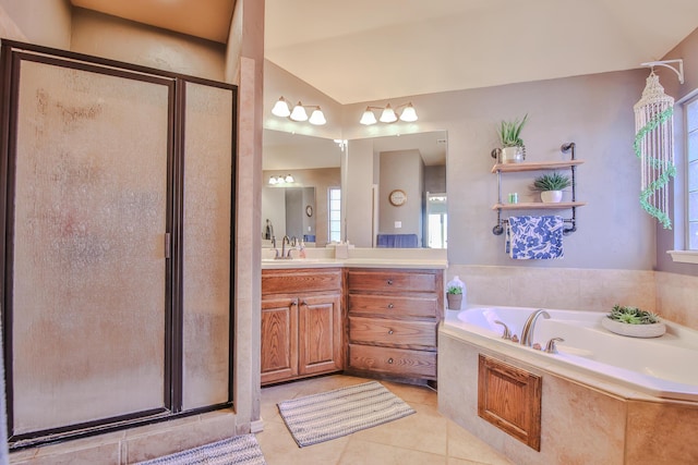 bathroom with a garden tub, a shower stall, tile patterned flooring, and vanity