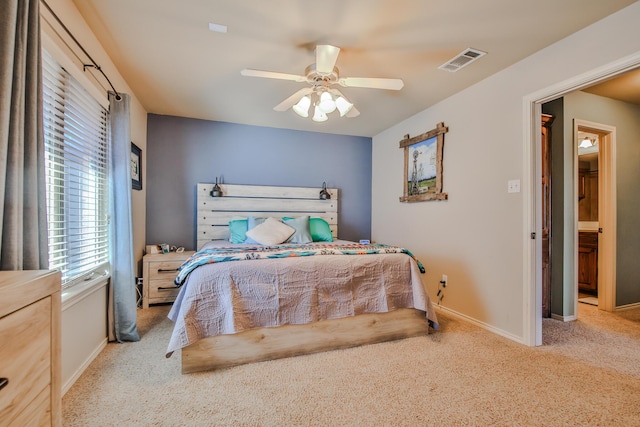 carpeted bedroom with ceiling fan, visible vents, and baseboards