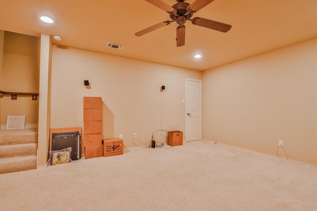 carpeted spare room with baseboards, visible vents, a ceiling fan, stairway, and recessed lighting