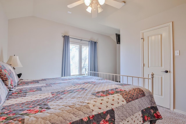 bedroom featuring carpet floors, vaulted ceiling, and a ceiling fan