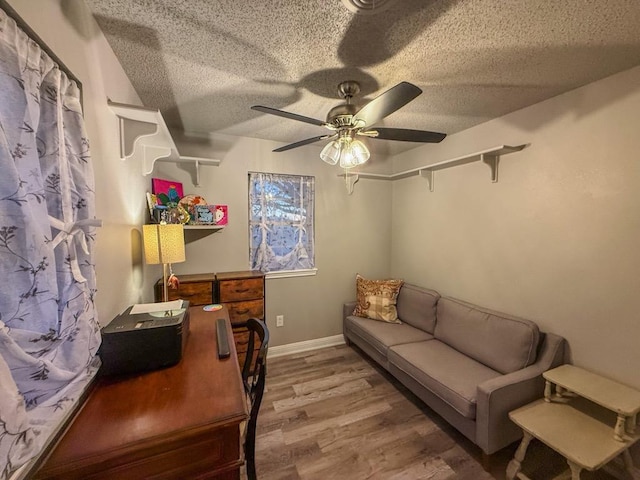 office space with hardwood / wood-style floors, a textured ceiling, and ceiling fan