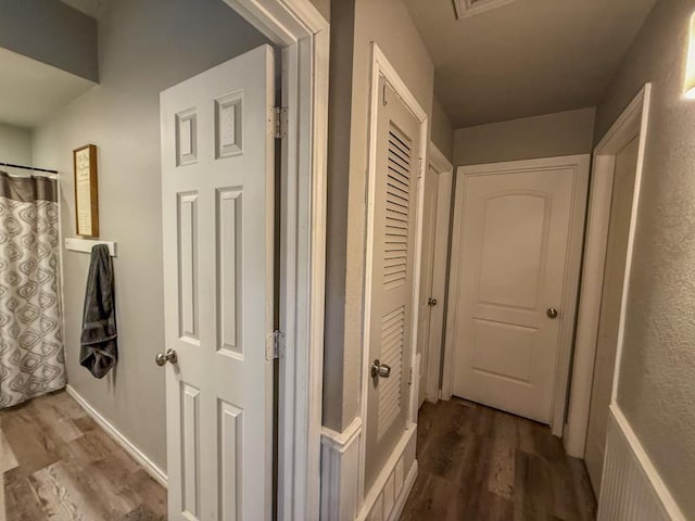 corridor with hardwood / wood-style floors