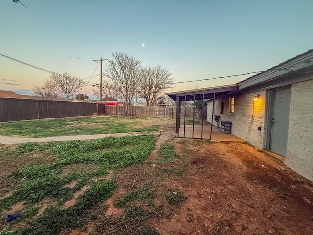 yard at dusk with a patio