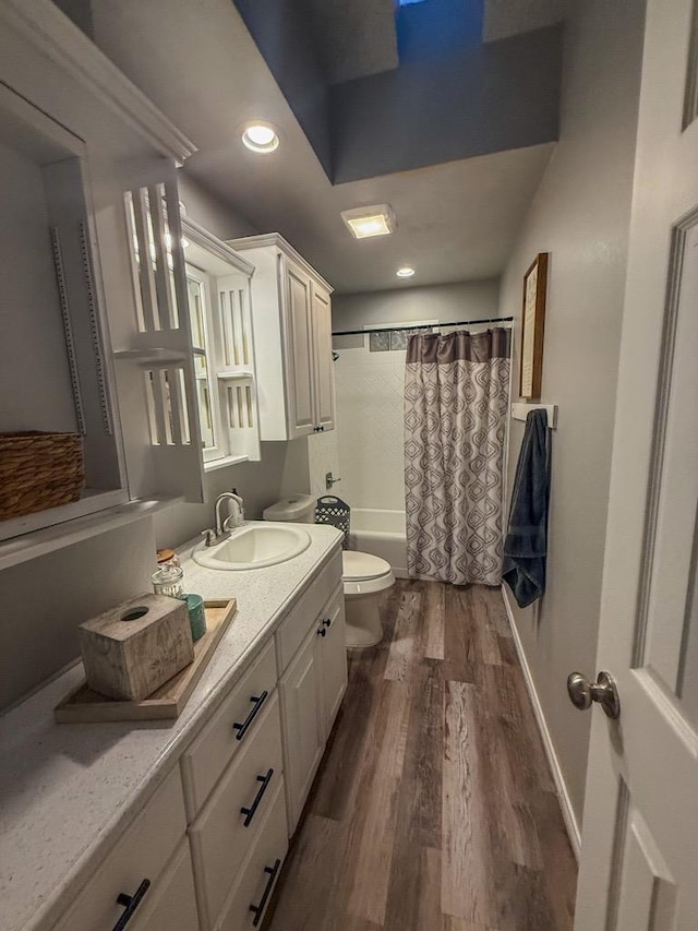 full bathroom featuring toilet, vanity, shower / bathtub combination with curtain, and wood-type flooring